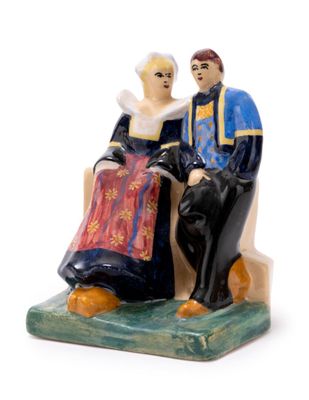 a figurine of a man and a woman sitting on a bench
