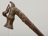 a close up of a metal object with a handle on a stand