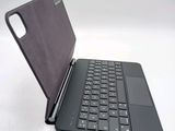 a black laptop with a black keyboard on a white surface