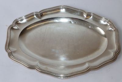 silver plate with scalloped edge on a white surface