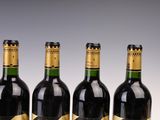 three bottles of wine are lined up on a table