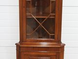 a wooden china cabinet with glass doors and drawers
