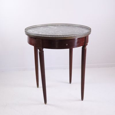 an image of a small round table with a marble top
