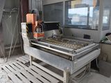 an image of a machine that is making doughnuts on a conveyor belt