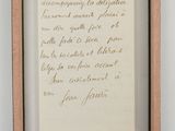 an old handwriting on a piece of paper in a wooden frame