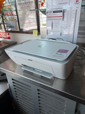 a white printer sitting on top of a metal table