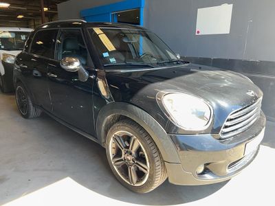 a picture of a black mini cooper parked in a garage
