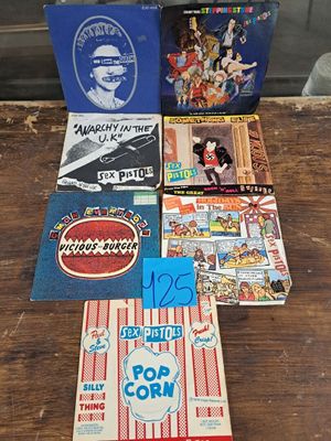 a lot of books on a table with a bag of popcorn