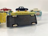 several toy cars are lined up in a row on a white surface
