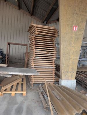 many pieces of wood stacked on top of each other in a warehouse