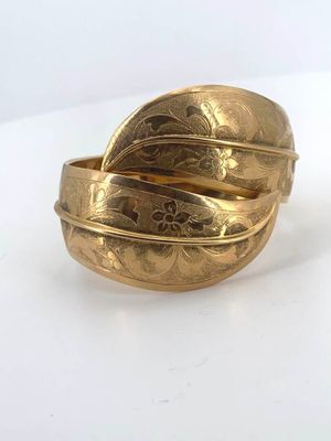 an image of a close up of a gold ring on a white surface