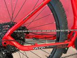 a red bike with a chain attached to the front wheel