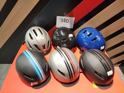 cinq casques posés sur une table, avec une étiquette de prix