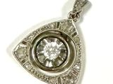 an image of a silver pendant with a diamond in the center
