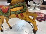 a wooden horse that is on display in a store