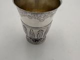 a silver cup that is sitting on a table