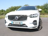 the front end of a white volvo suv parked in a parking lot