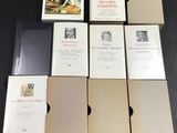 several books are stacked on top of each other on a table