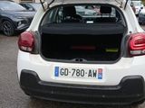 a white car with its trunk open in a parking lot