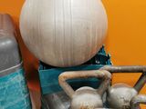 a white ball sitting on top of a stack of luggage