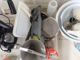 a pile of dirty dishes and utensils on the kitchen counter