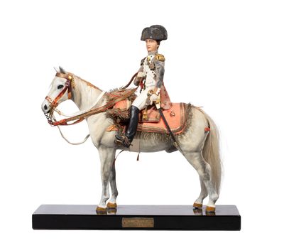 figurine of a man riding a horse on a black base