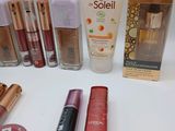 many different makeup products on a white table