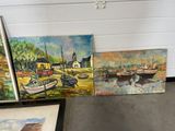 many paintings of boats on display in a room