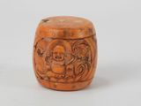 an old wooden box with carvings on it sitting on a white surface