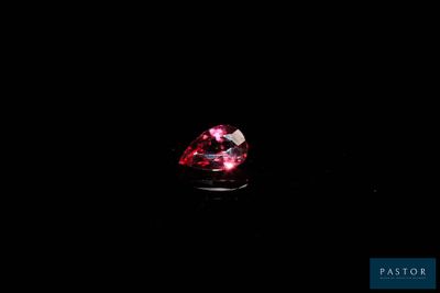 a close up of a red diamond on a black background