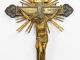 an antique brass crucifix with a sunburst in the center