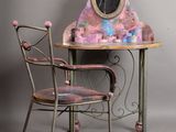 two chairs and a table with a mirror on it