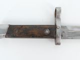 a knife with a wooden handle on a white surface
