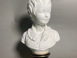 a white bust of a woman on a black base