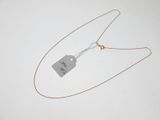 a close up of a necklace with a tag attached to it