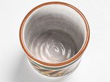 a close up of a small bowl on a white surface