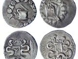four silver coins with designs on them on a white background
