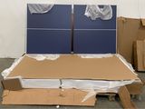two blue ping pong boards on top of a cardboard box