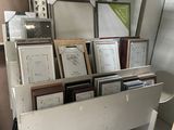 a picture of a room with a bunch of framed pictures on the wall