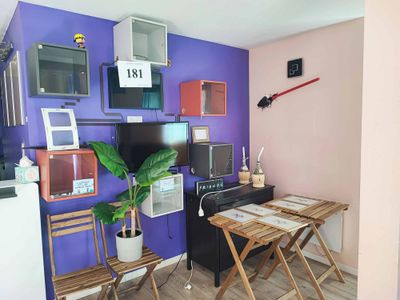 a small table and chairs in a room with purple walls