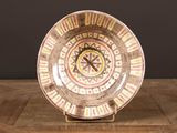 a plate with a clock on it on a wooden table