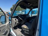 a blue truck with its door open next to a blue van