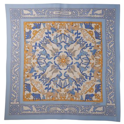 a blue and yellow square scarf with a floral design