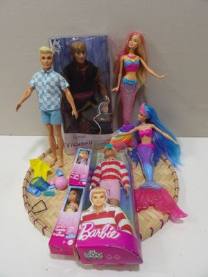 three barbie dolls that are sitting on a table