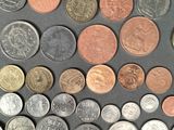 a lot of different coins that are on the table