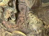 a bronze clock with a man and a woman on the front of it