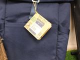 a bag with a tennis racket and a bag with a bag tag on it