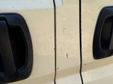 a close up of the door handles on a white truck