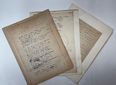 three old papers with writing on them sitting on top of a table
