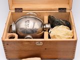 a wooden box with a silver plate inside of it